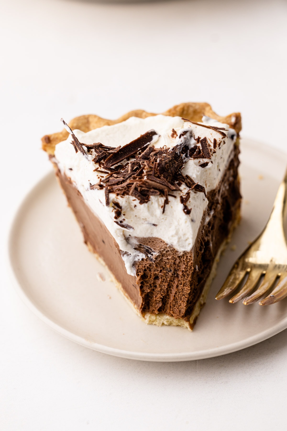 A slice of French silk pie with a bite taken out of it.