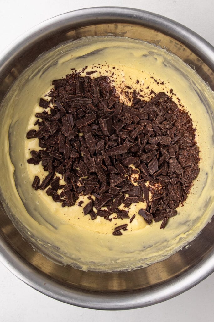 Adding chopped chocolate to a pate a bombe for French silk pie.