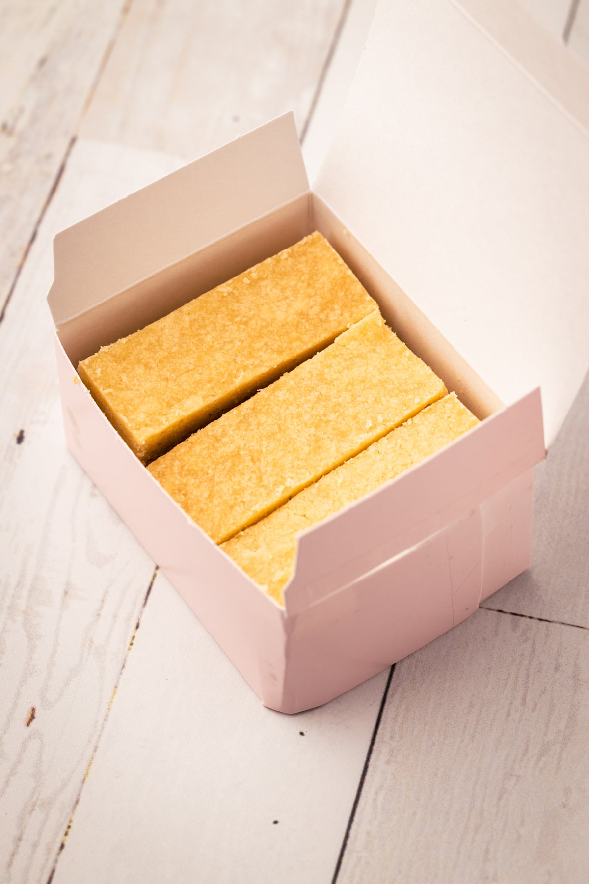 A pink box with Ted Lasso biscuits.