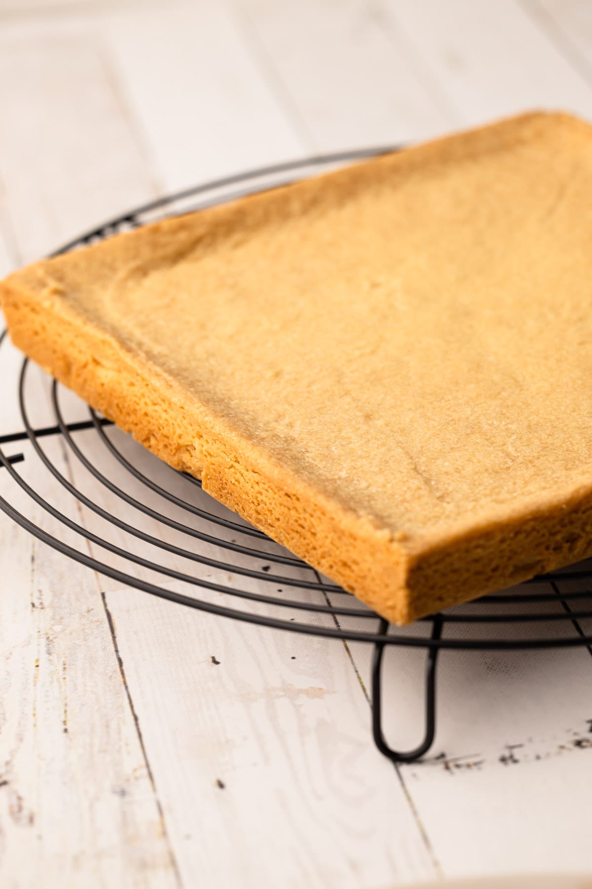 The ted lasso shortbread biscuits uncut and cooling on a rack.