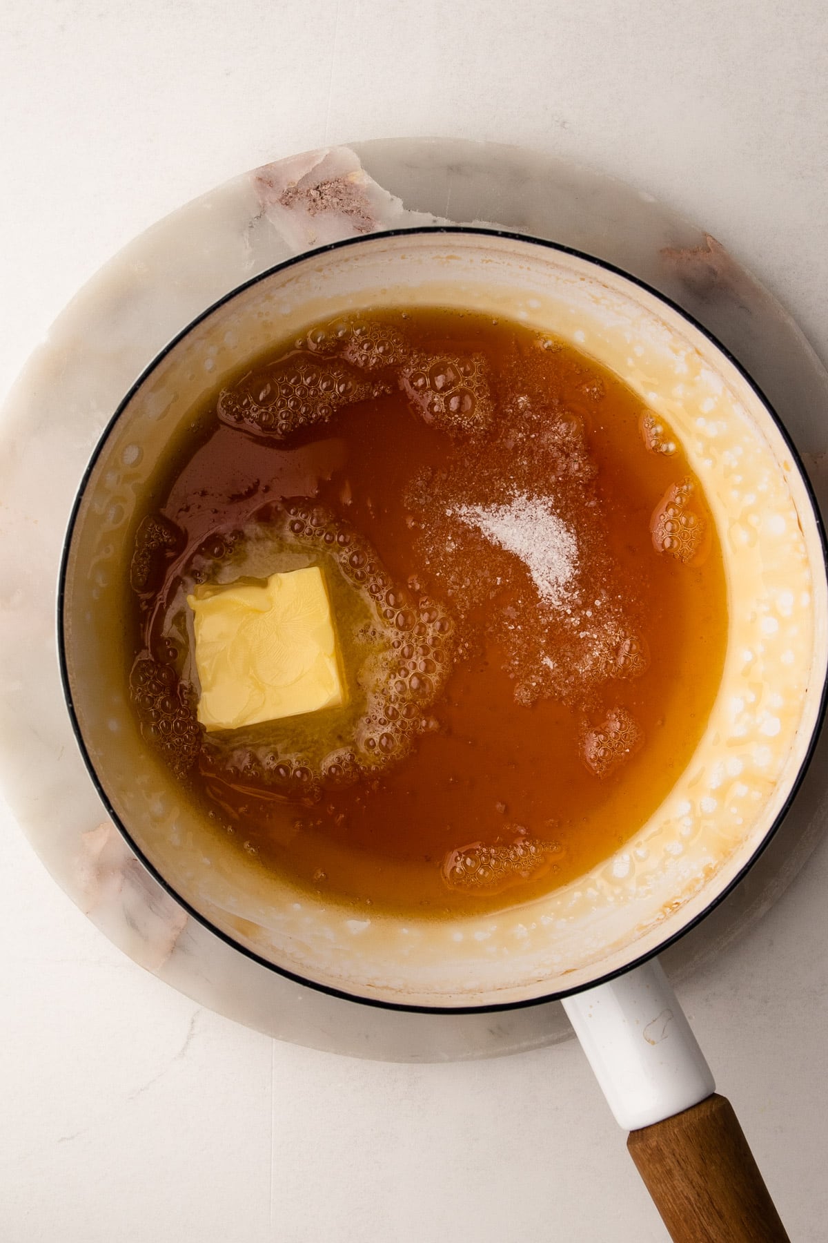 Adding butter to make caramel for tarte tatin.