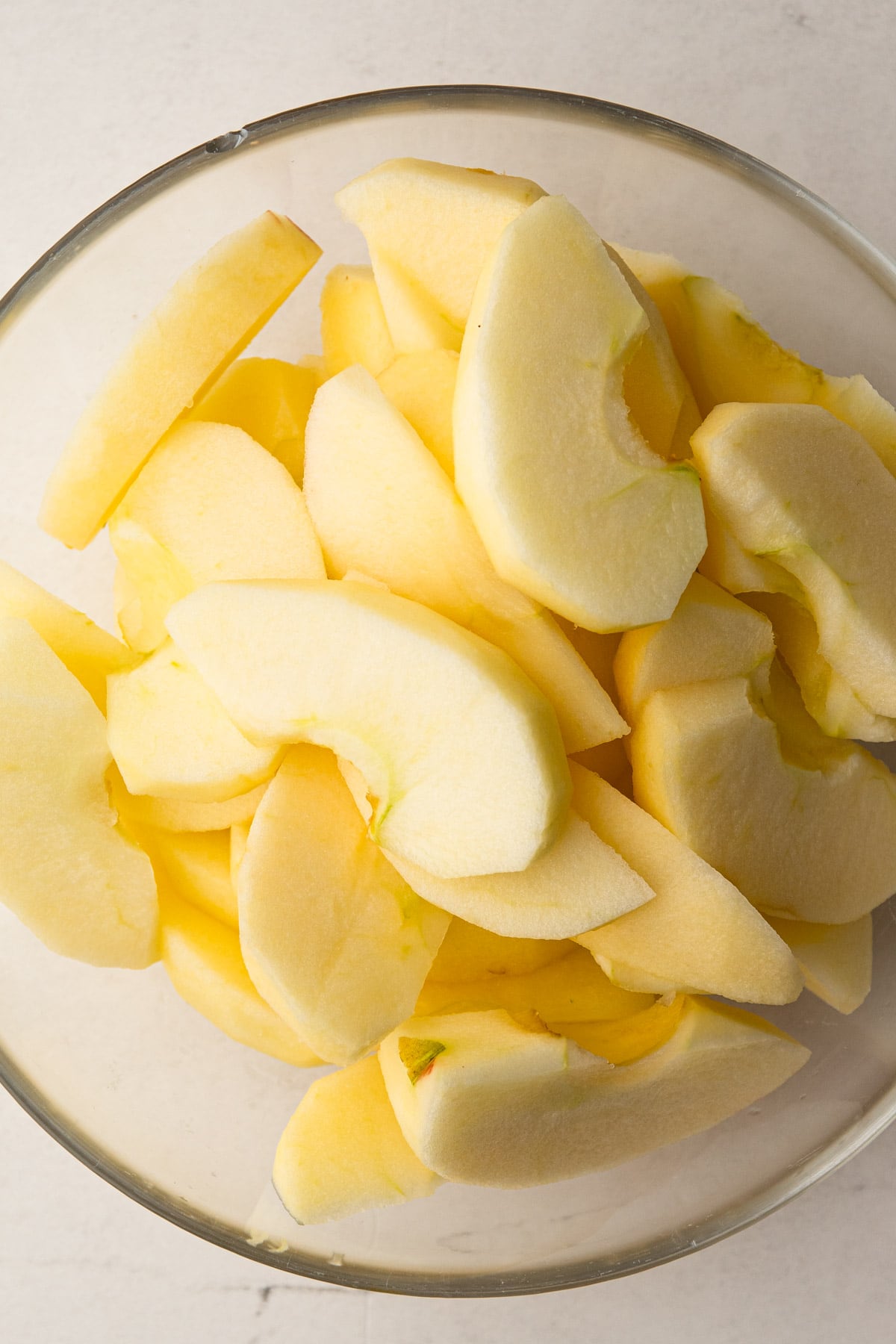 Apple wedges in a bowl with lemon juice.