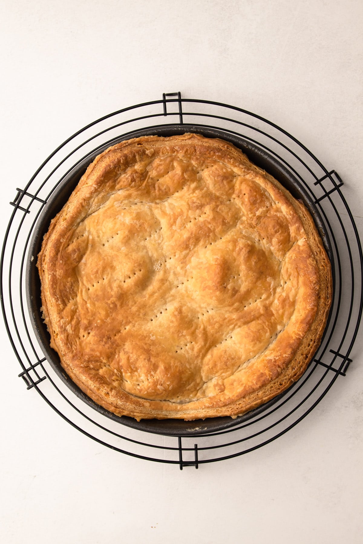 A baked apple tarte tatin before it is inverted.