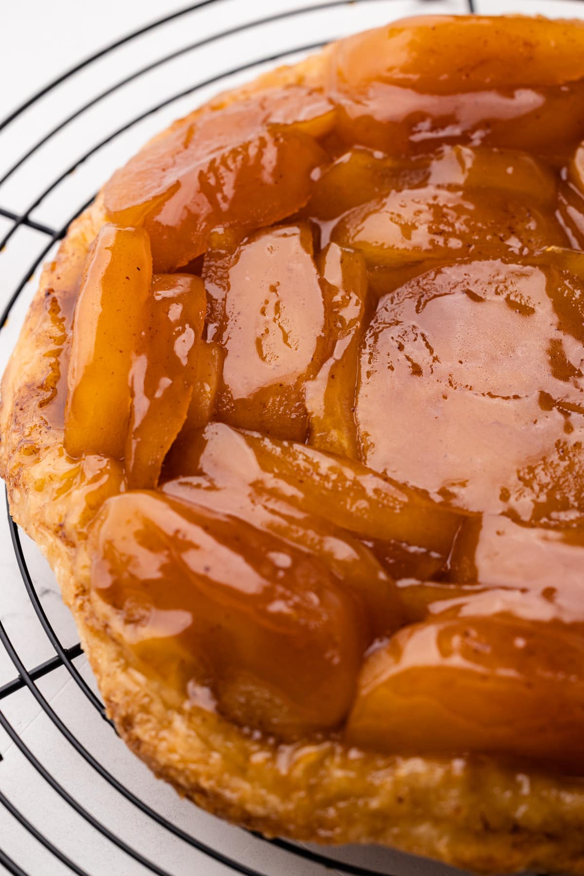 A beautiful apple tarte tatin on a cooling rack.