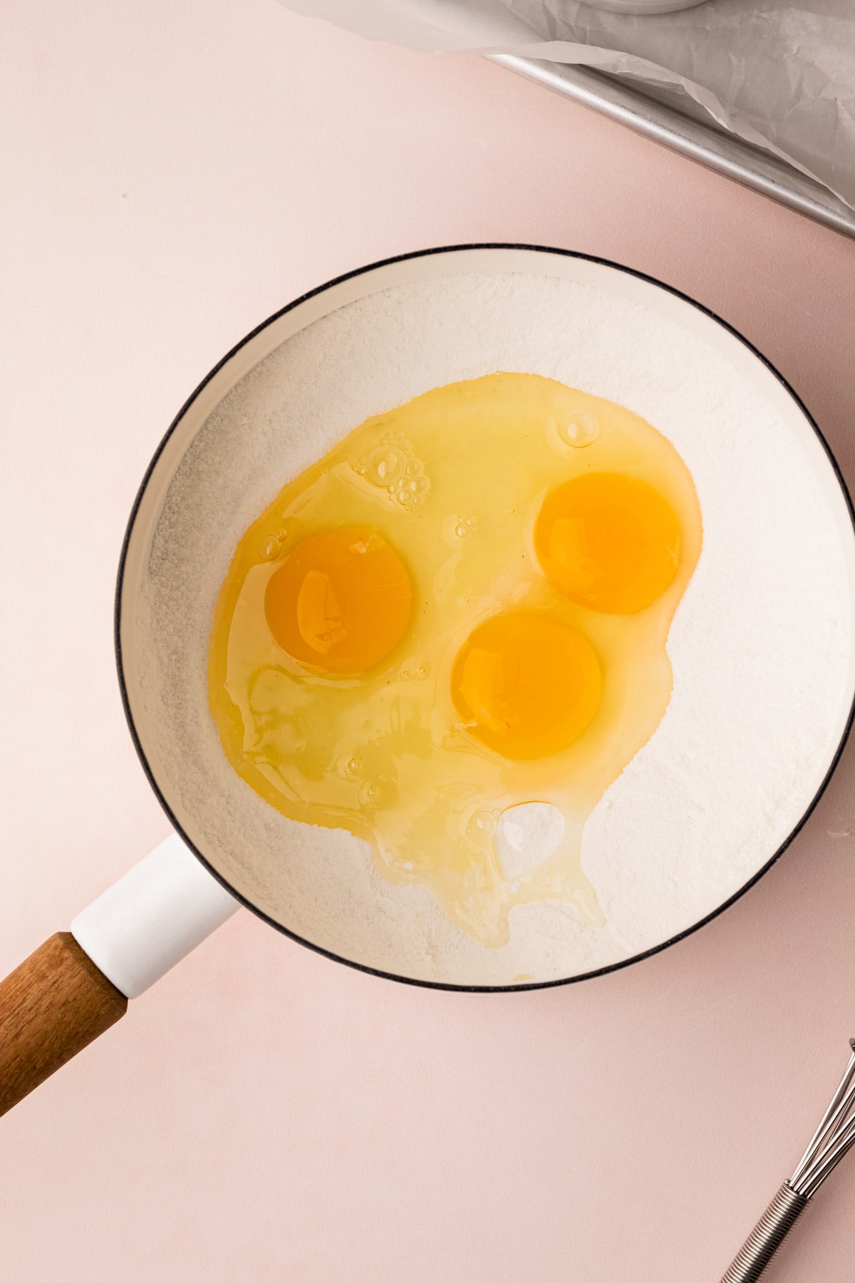 Sugar, cornstarch and eggs in a pot for pistachio pudding.