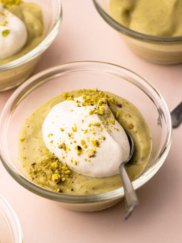A couple of bowls with homemade pistachio pudding and whipped cream.