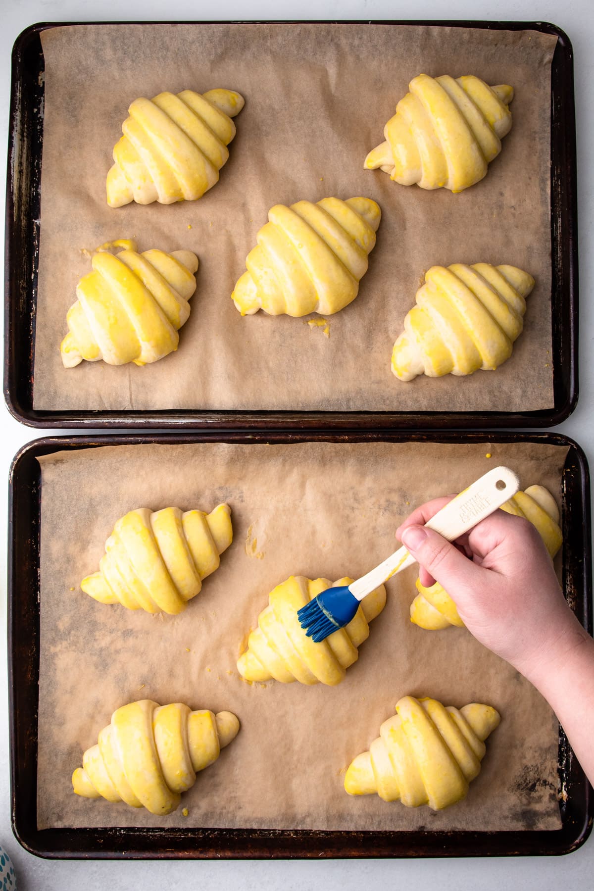 Egg washing croissants.