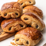 A stack of baked chocolate croissants.