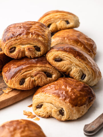 A stack of baked chocolate croissants.