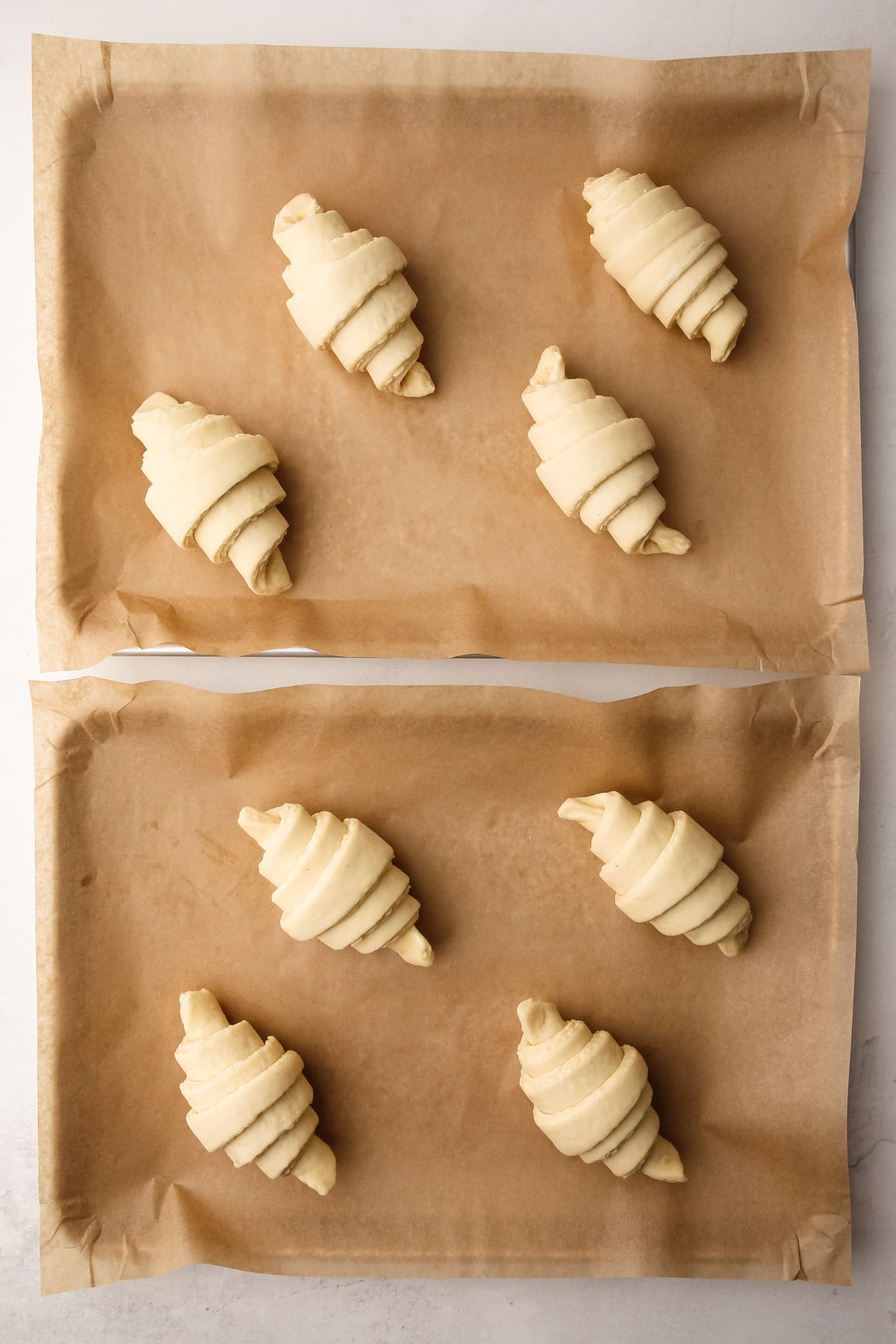 Shaped croissants on a baking tray.