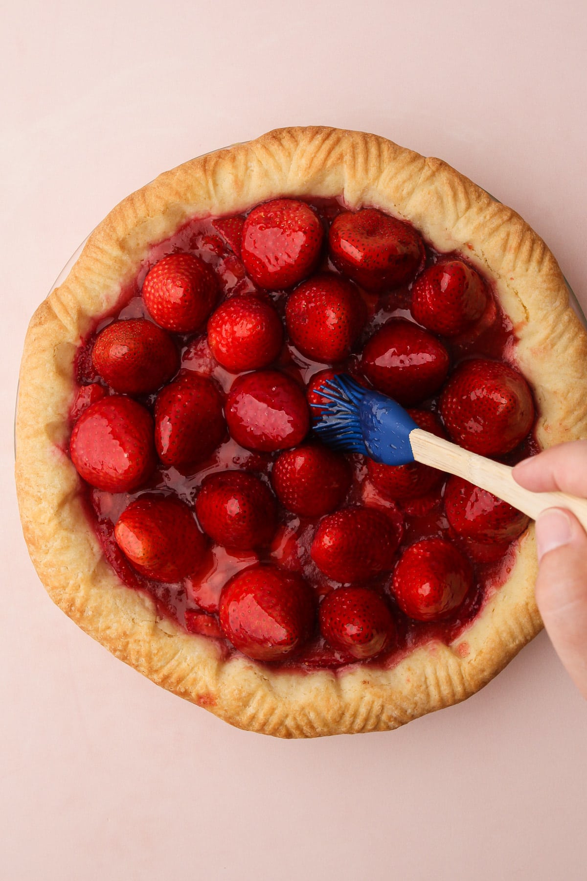 Glazing fresh strawberry pie.