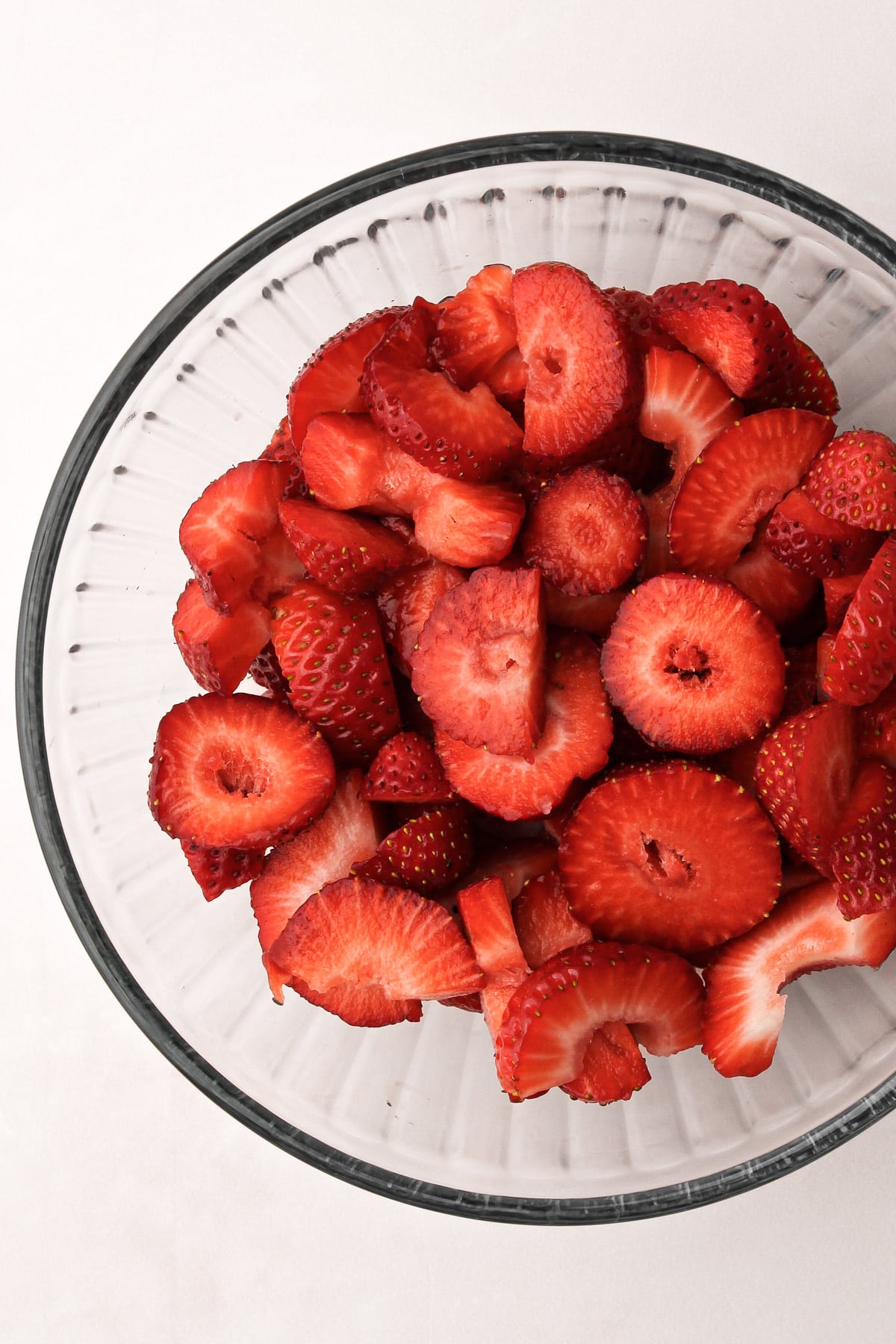 A bowl of sliced strawberries.