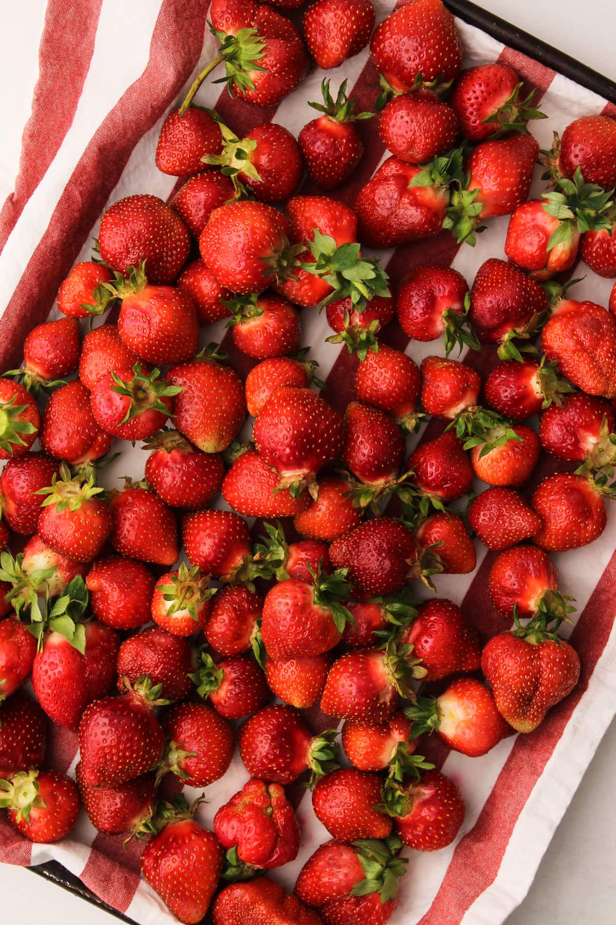 A tray of cleaned strawberries.