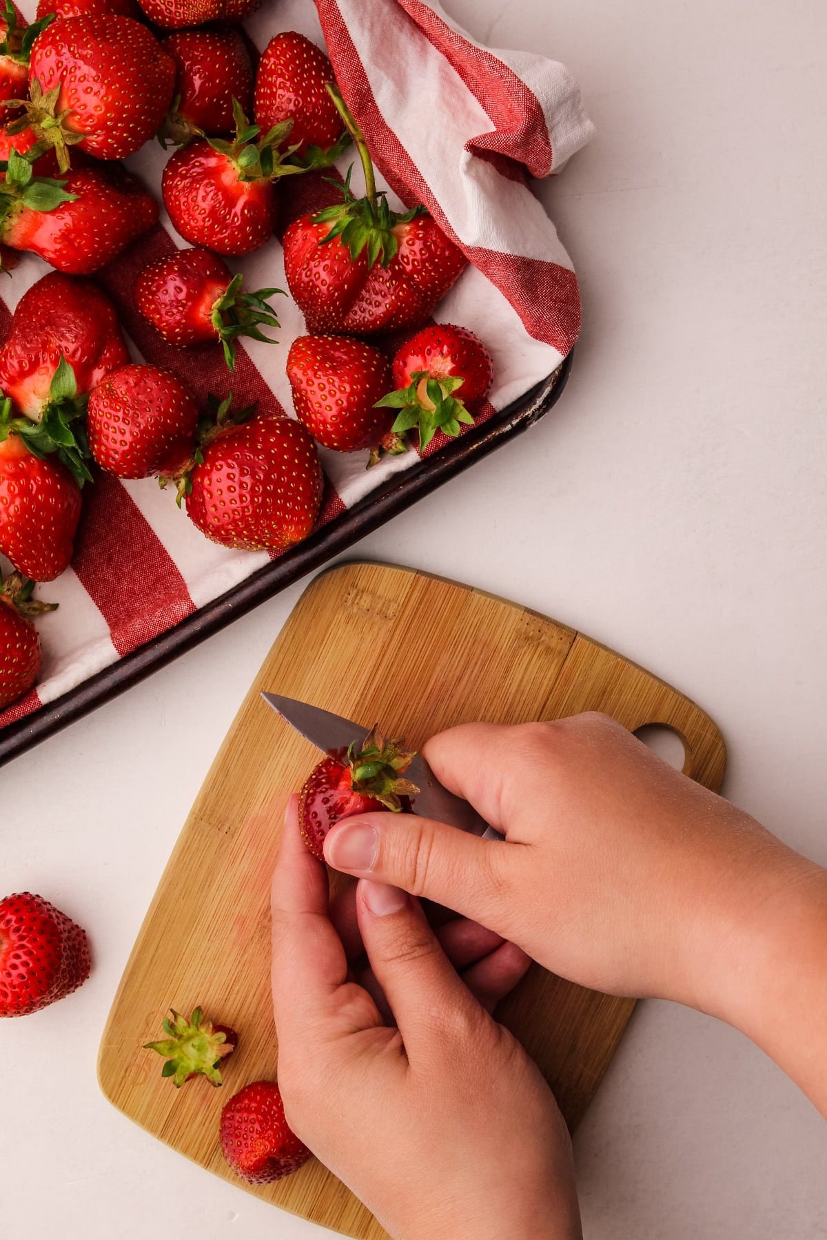 Cutting strawberries.