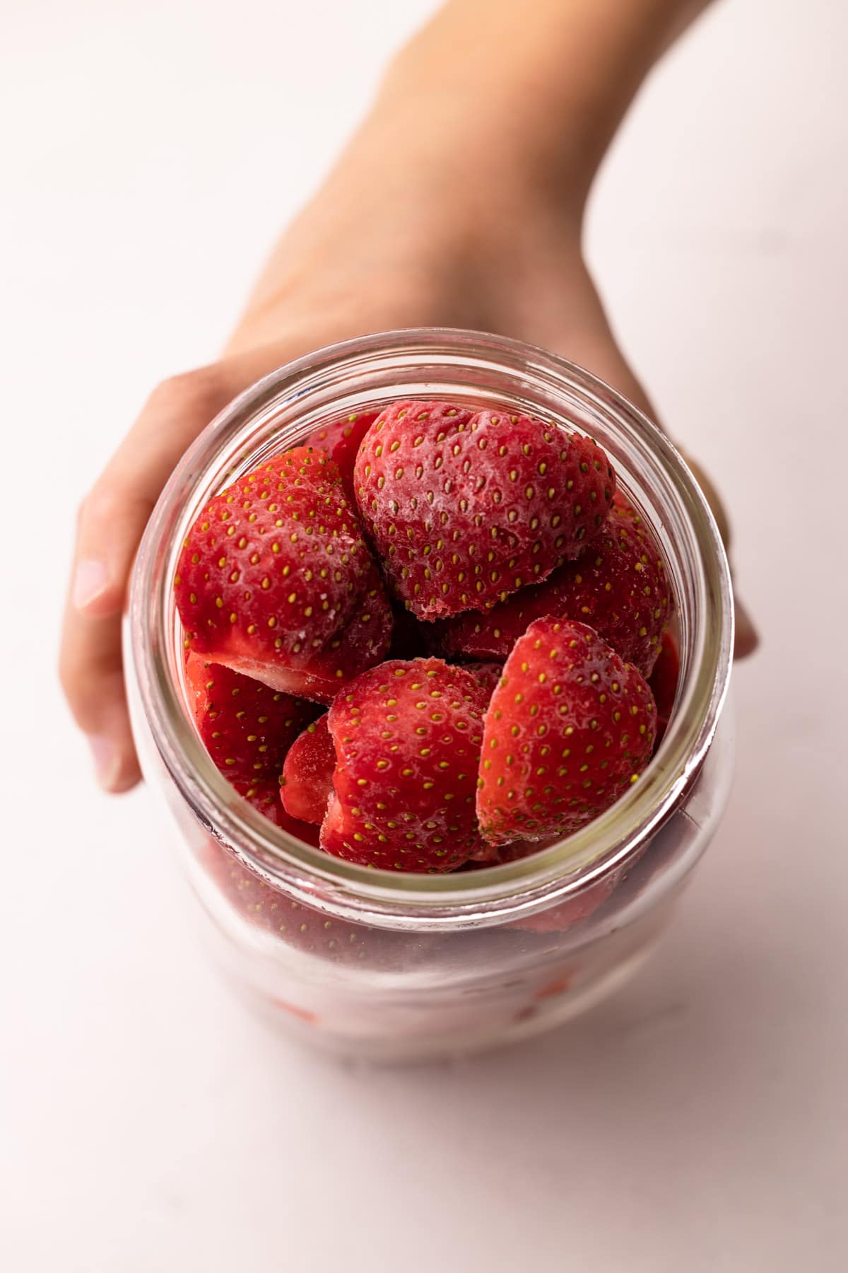 A jar of frozen strawberries.