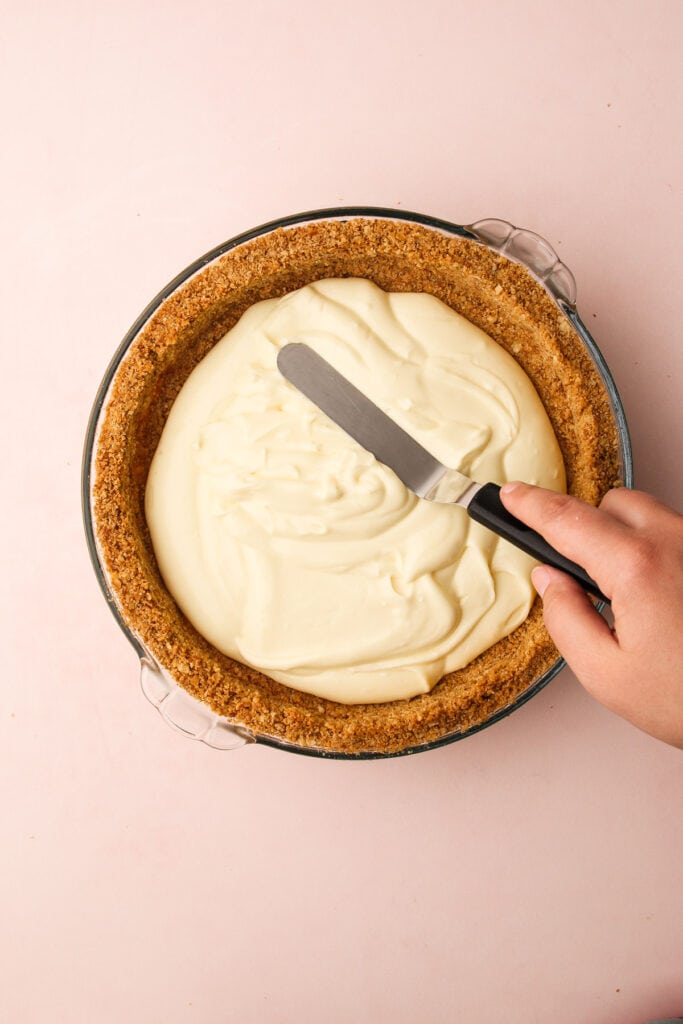 Preparing the filling for the strawberry cream cheese pie.