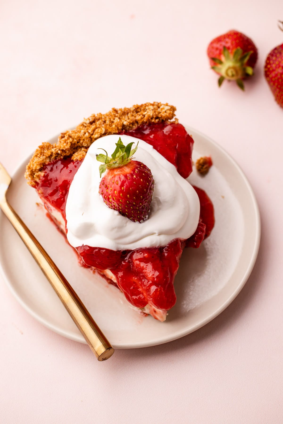 A slice of strawberry cream cheese pie on a plate.