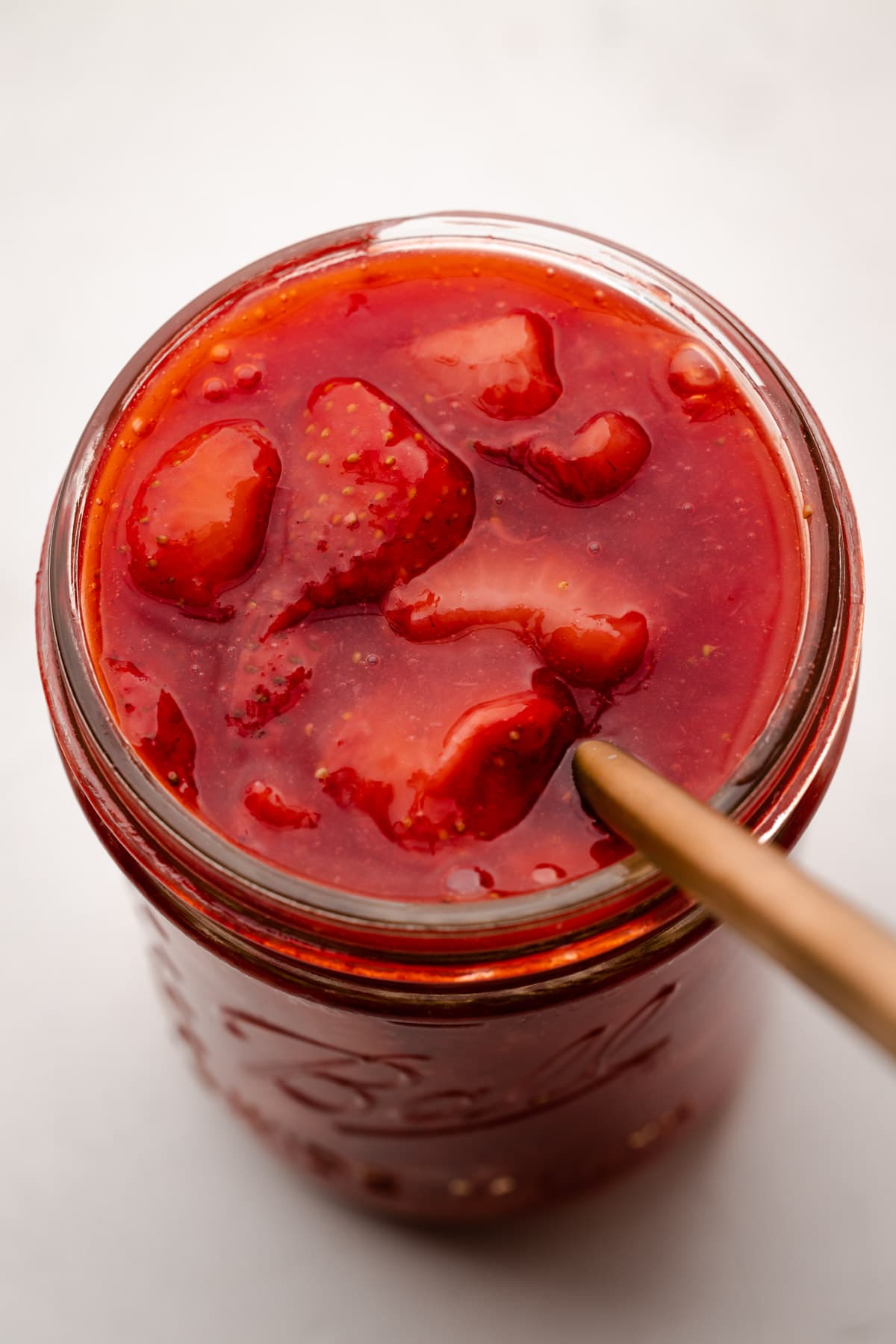 A jar of strawberry pie filling.