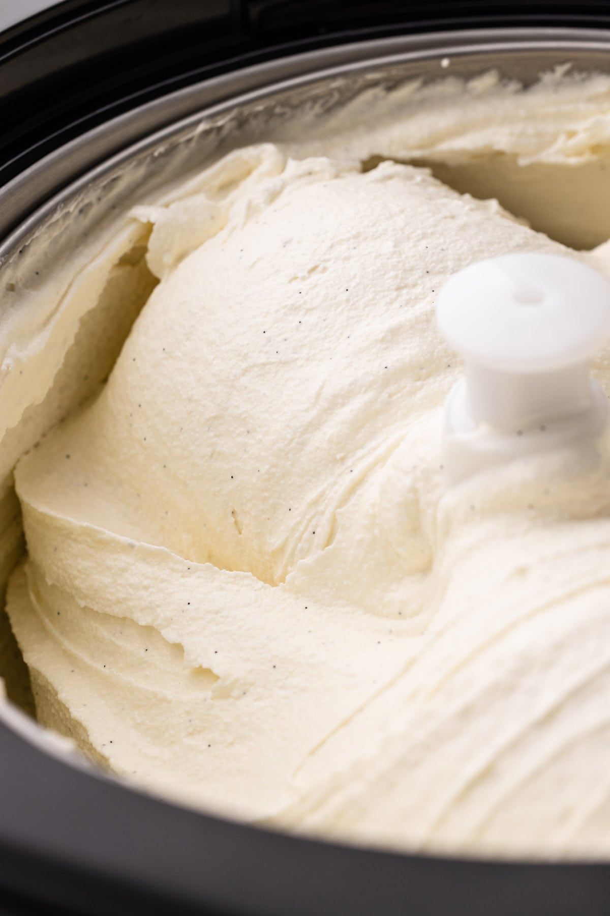 Homemade vanilla bean ice cream in an ice cream machine.