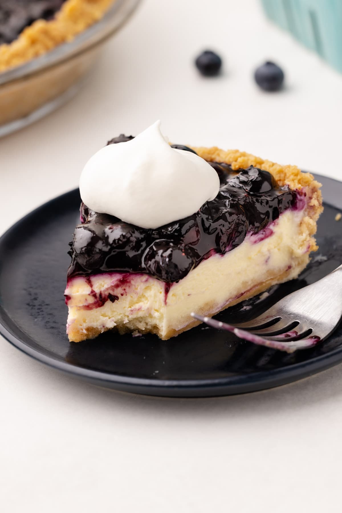 A blueberry cream cheese pie on a plate.