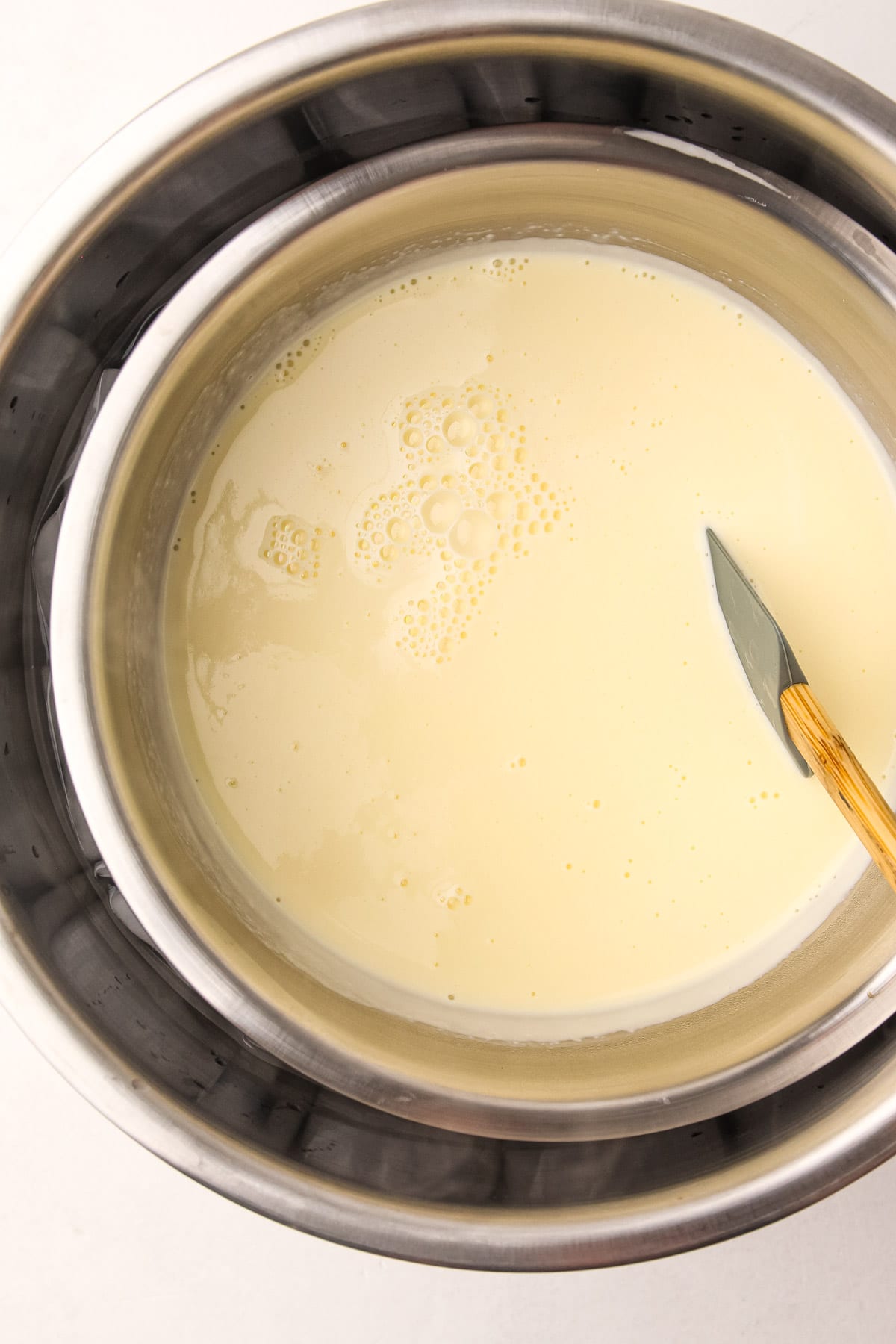 Making a custard base for blueberry ice cream.