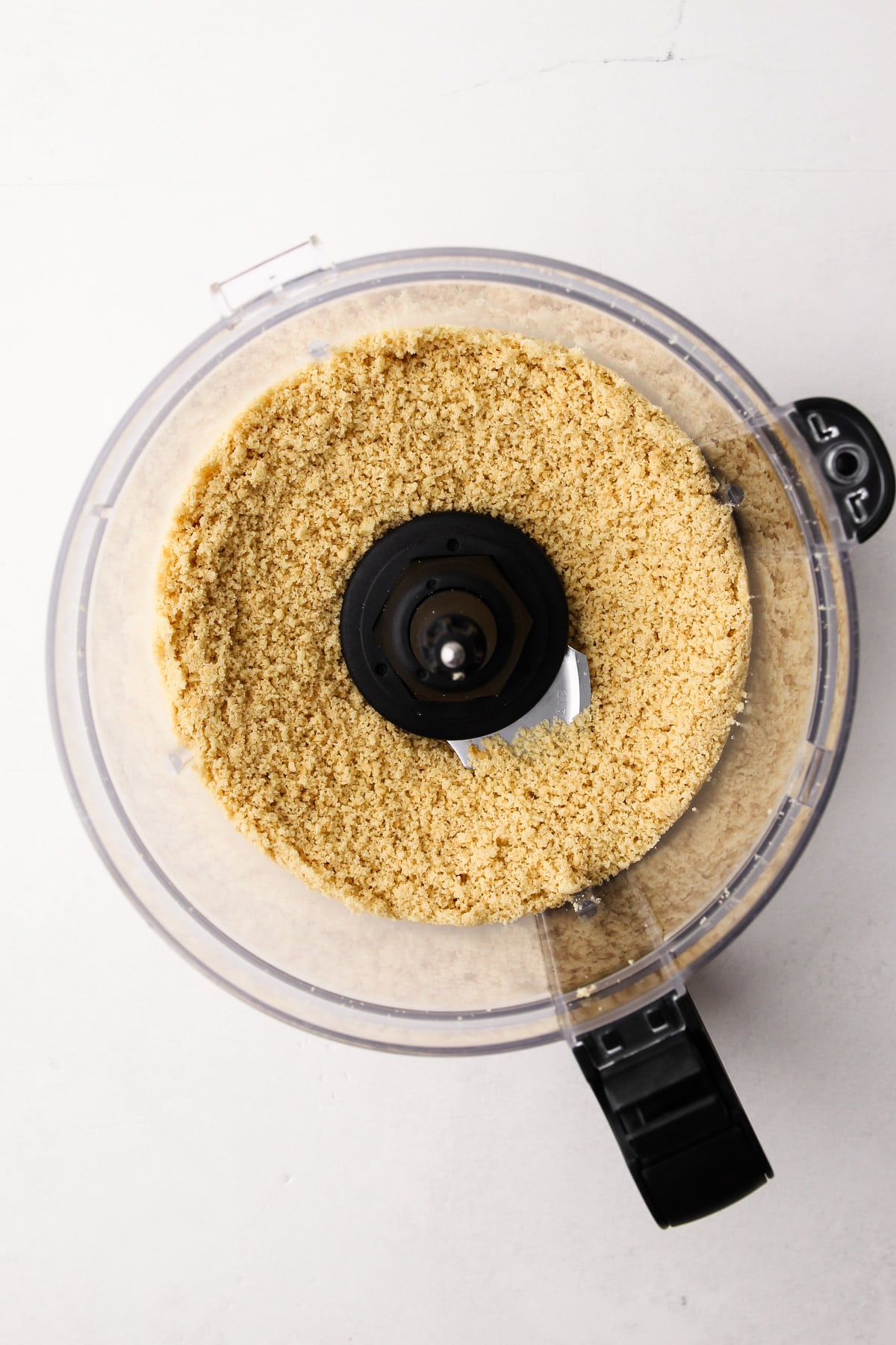 Pulverized cookie crumbs in a food processor.