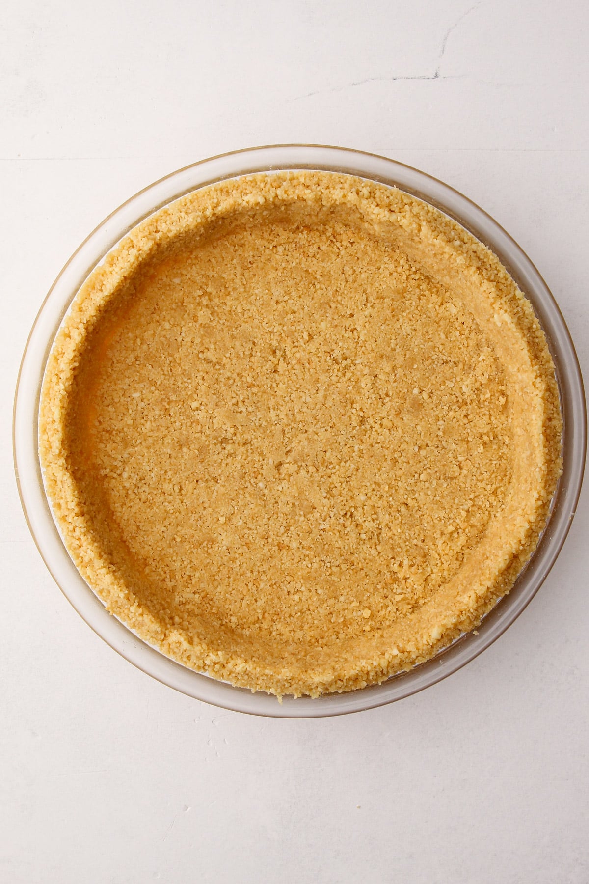 A shortbread cookie crust in a pie plate.