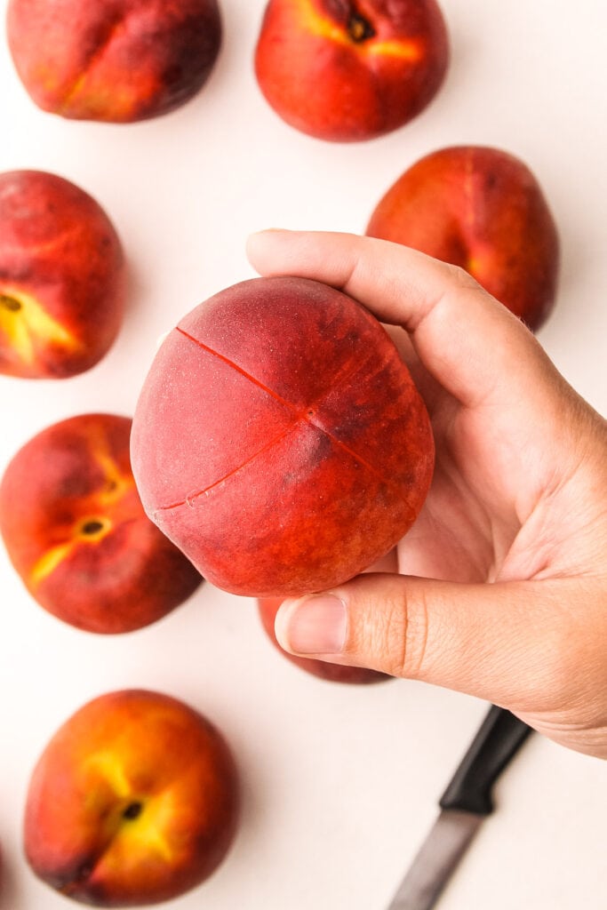 A peach prepared for blanching.