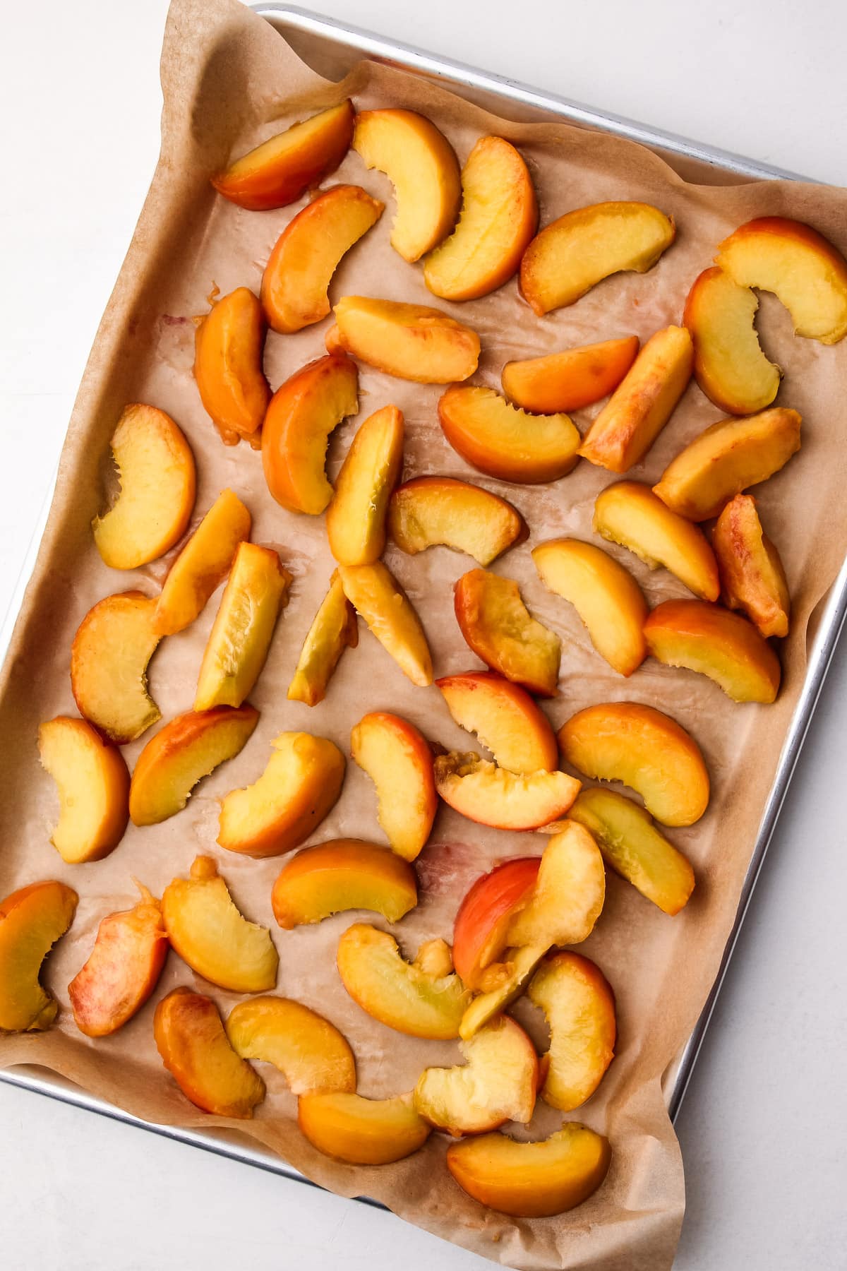 Peaches frozen on a tray.