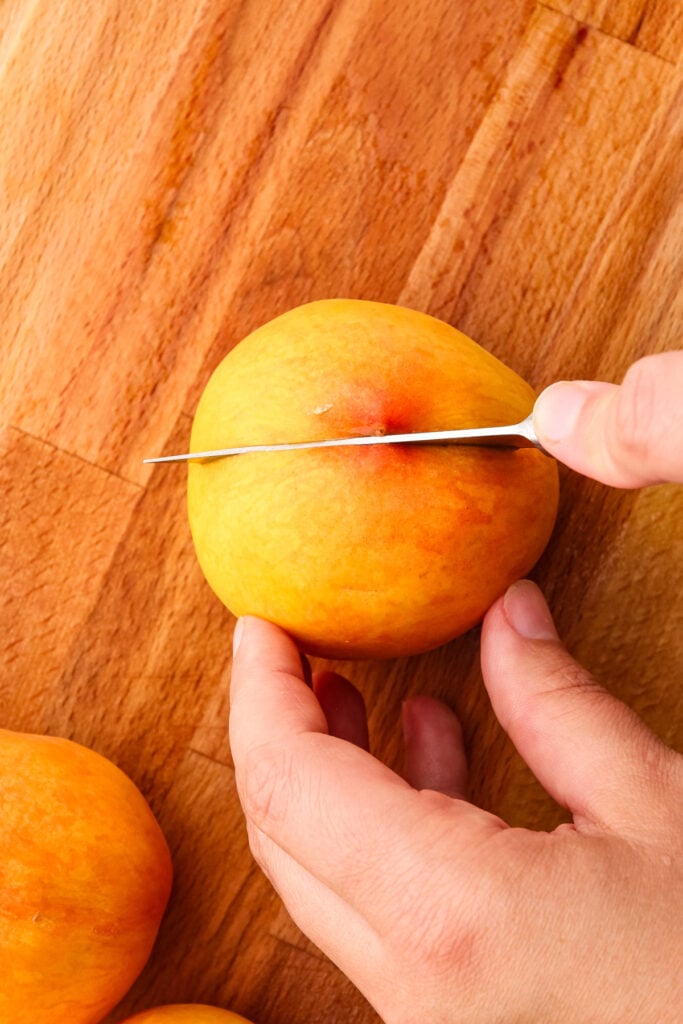 Slicing open peaches.