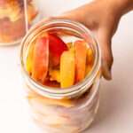 Frozen peaches in a mason jar.