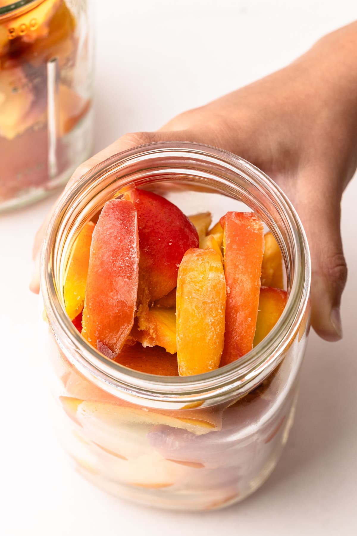 Frozen peaches in a jar.