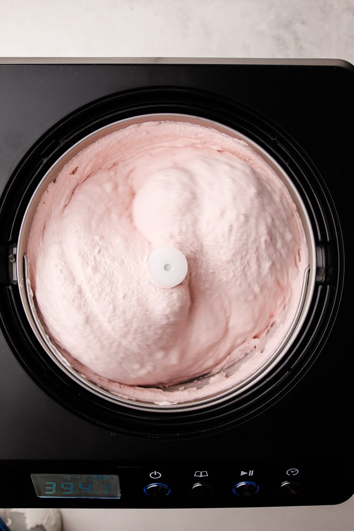 Churning strawberry ice cream from scratch.