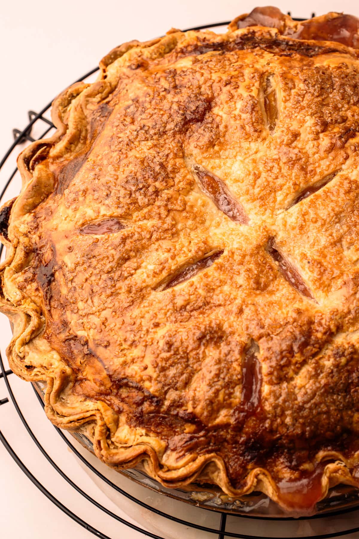 A baked peach pie with a golden brown pastry.