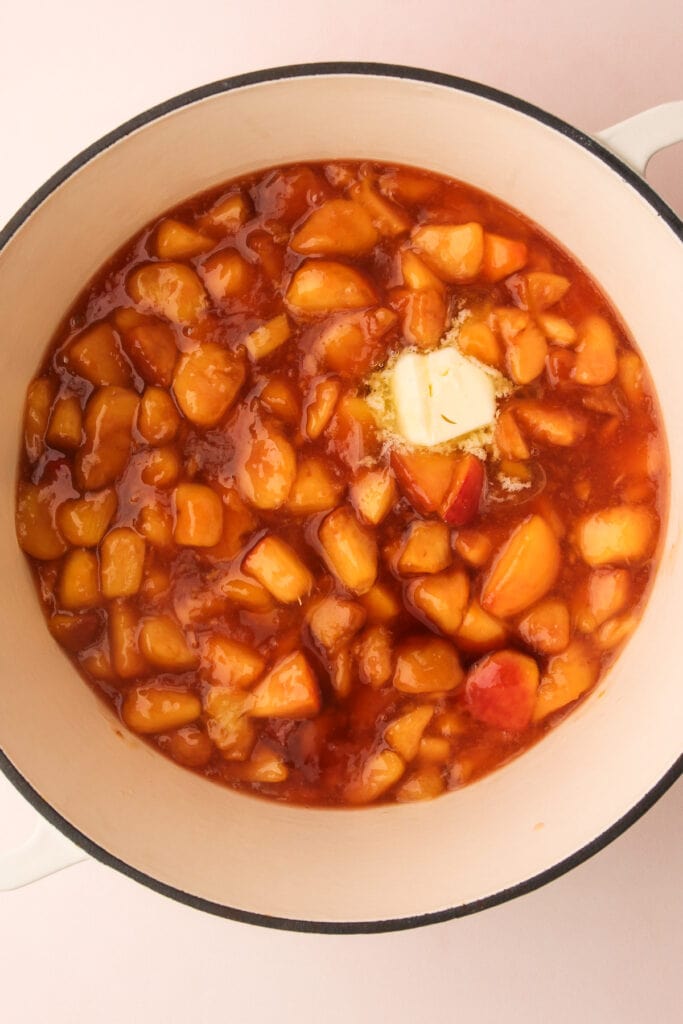 Cooking peach pie filling in a pot.