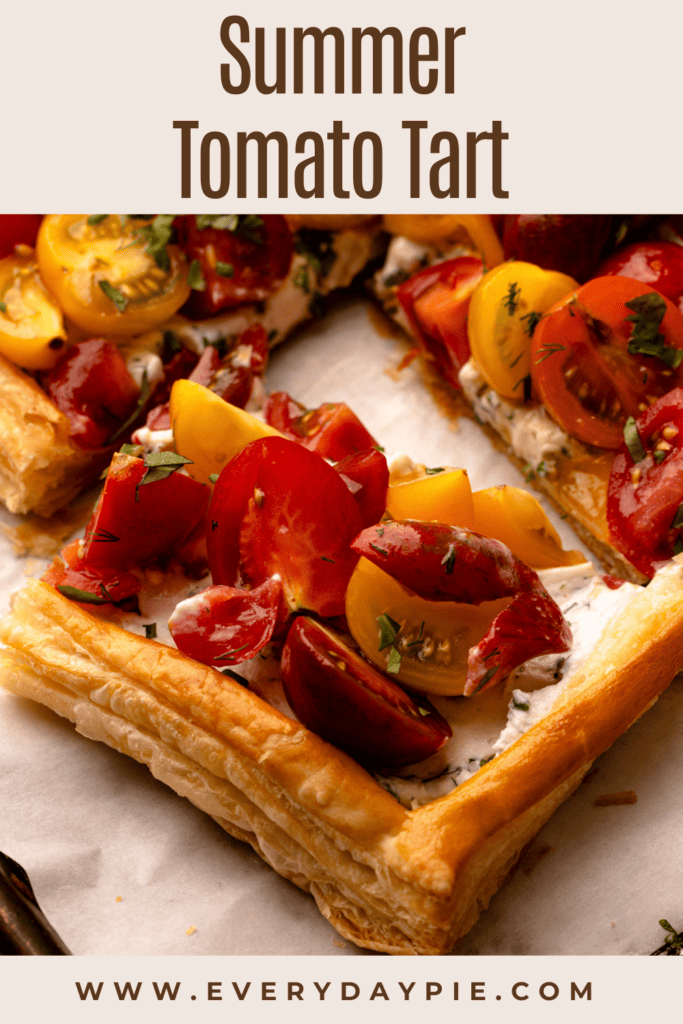 A sliced tomato tart with cherry tomatoes.