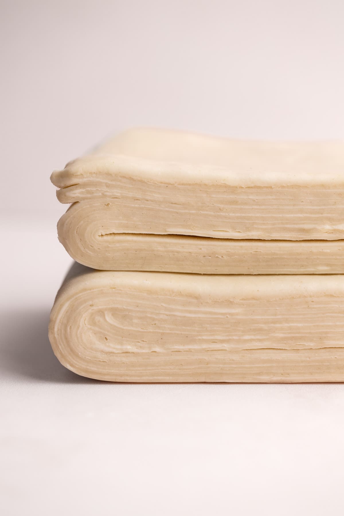 A close up image of the layers of butter and dough in homemade puff pastry.