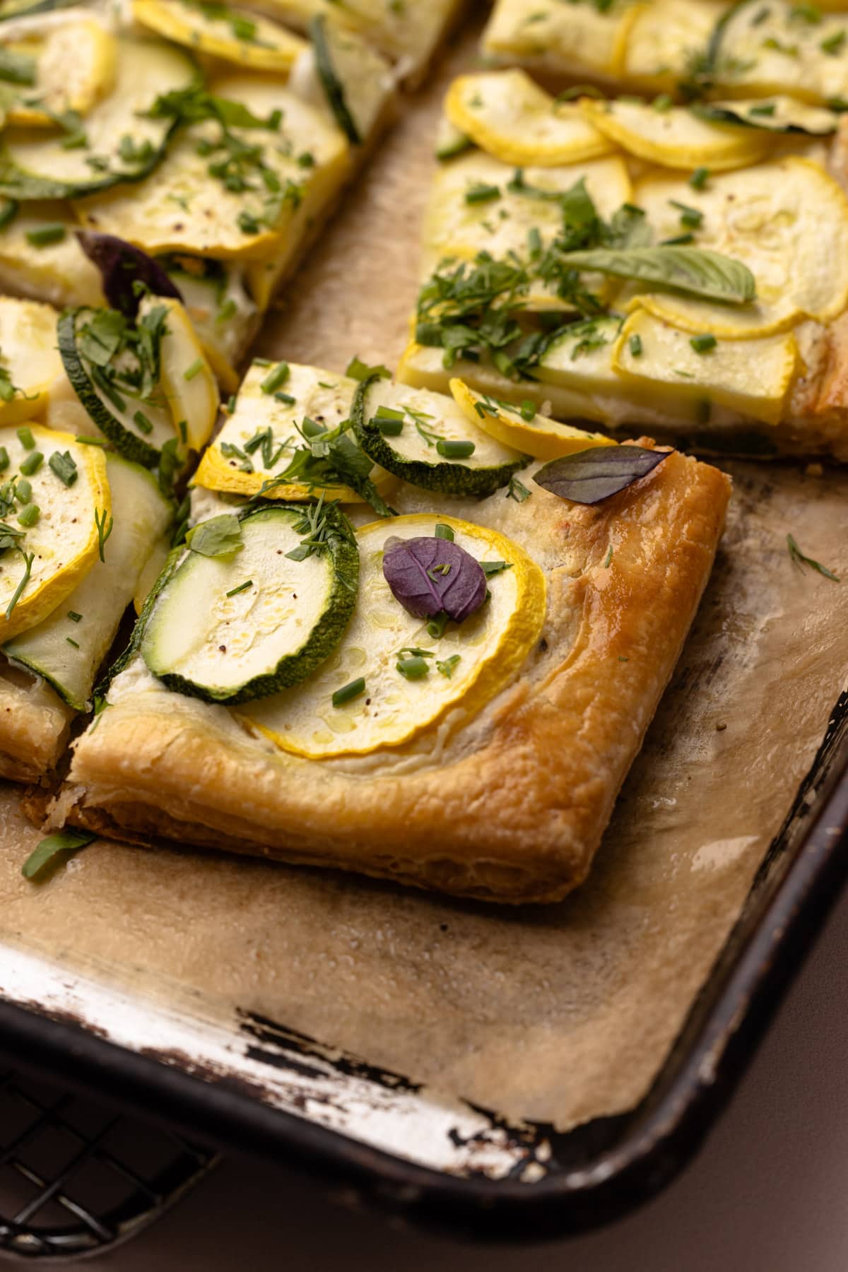 A cut zucchini tart made with puff pastry.