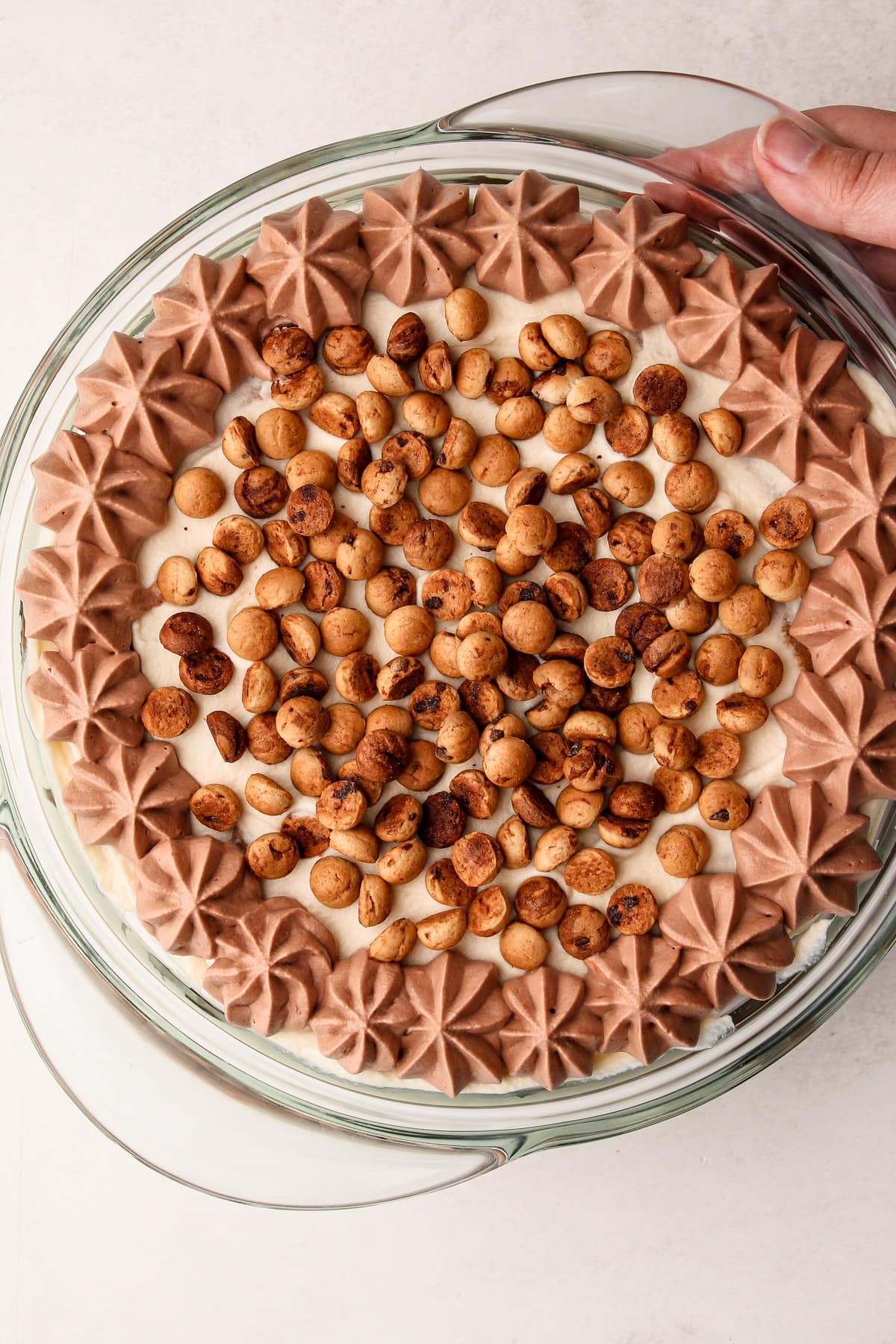 A cookie icebox cake in a clear round dish.