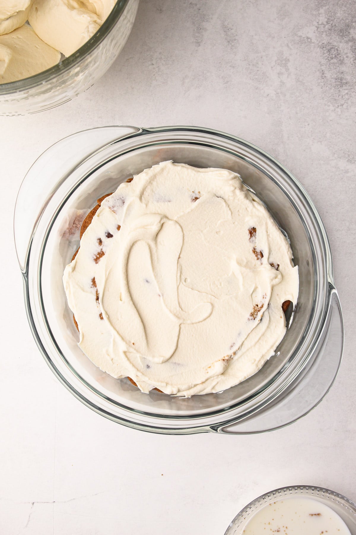 The second cream layer to a milk and cookie icebox cake.