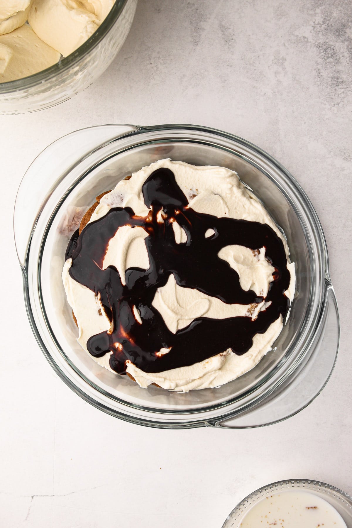 A layer of chocolate ganache in the prep for a milk and cookie icebox cake.