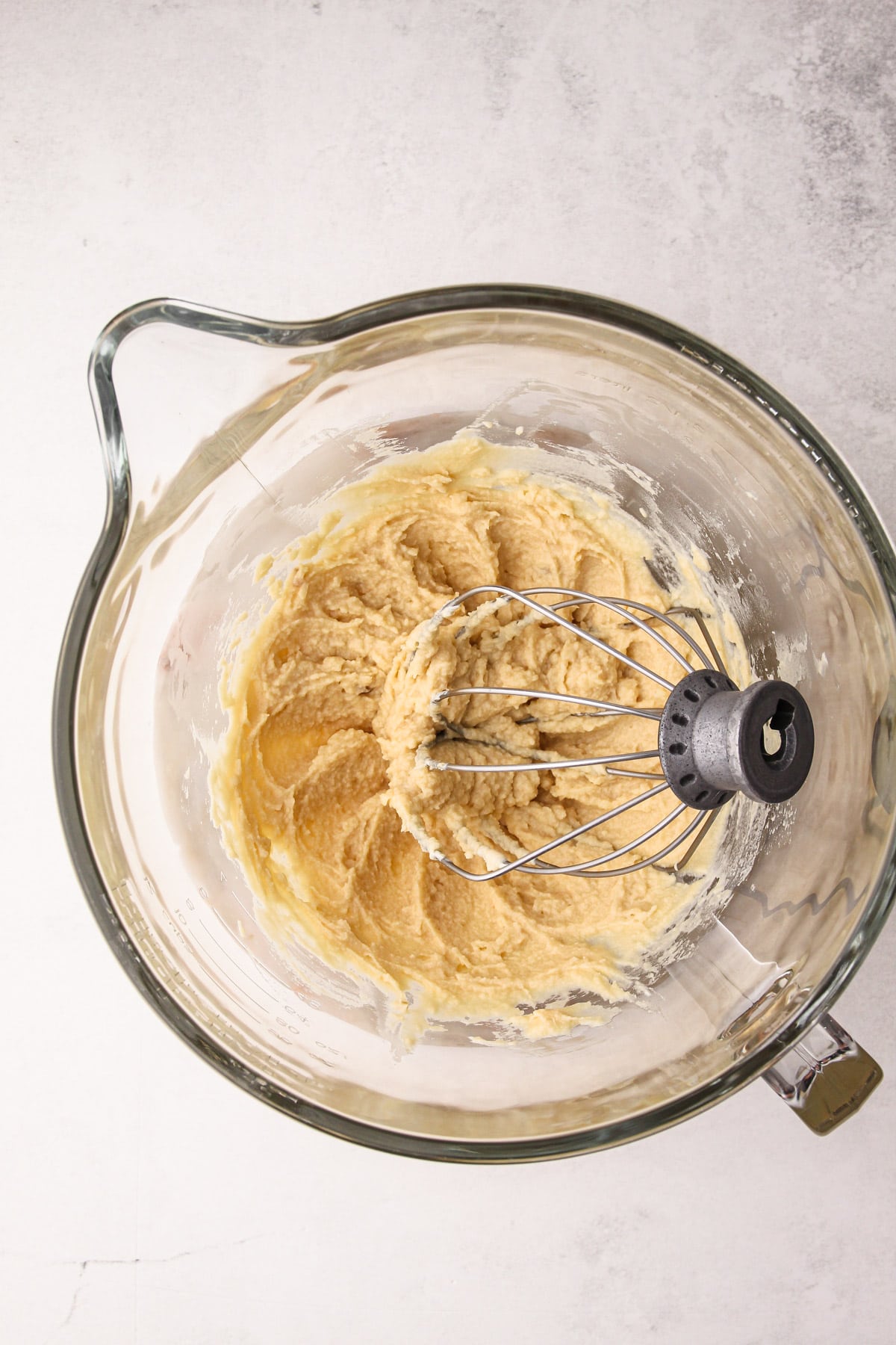 Mascarpone and brown sugar whipped in an electric mixing bowl.