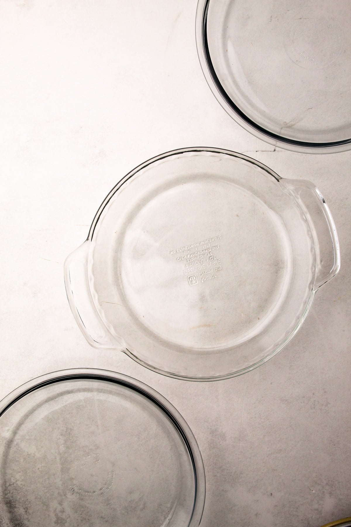 3 glass pie plates, one with handles