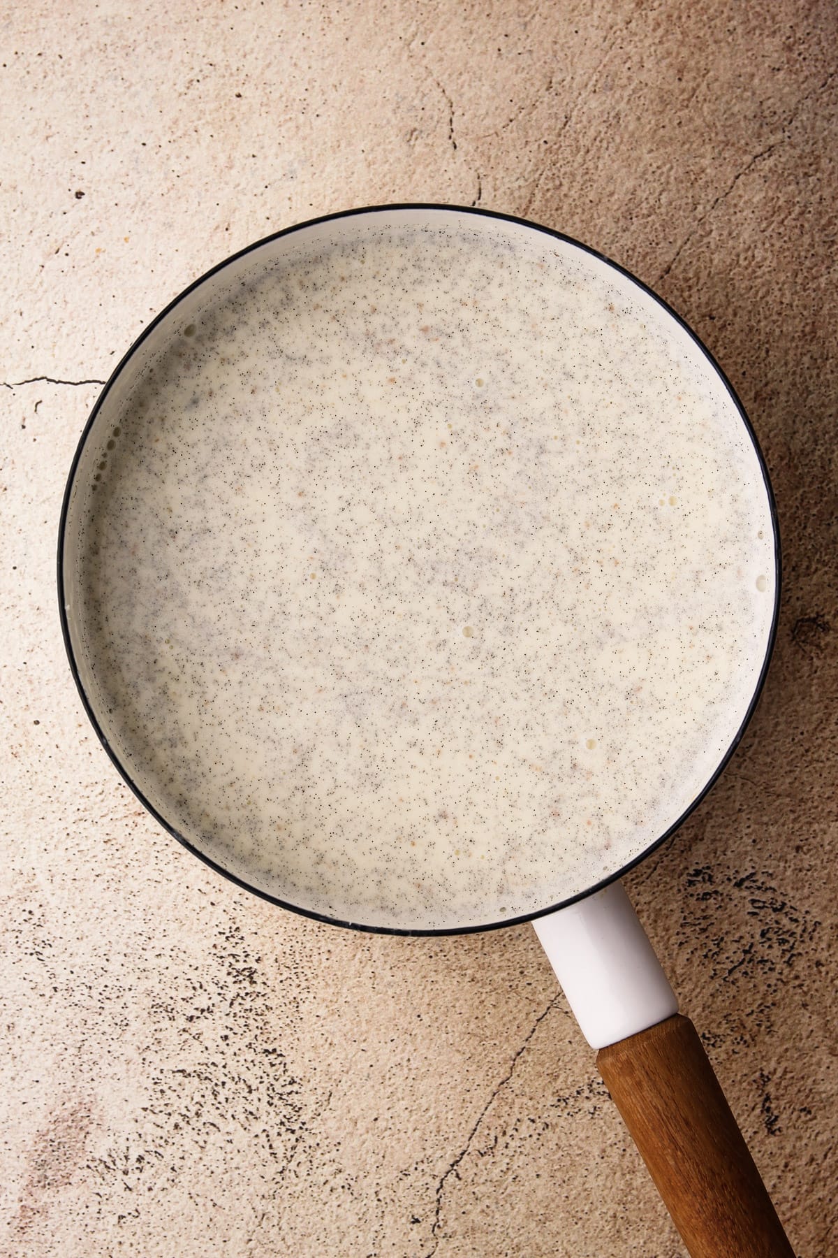 A pot of the mixture to make vanilla bean panna cotta.