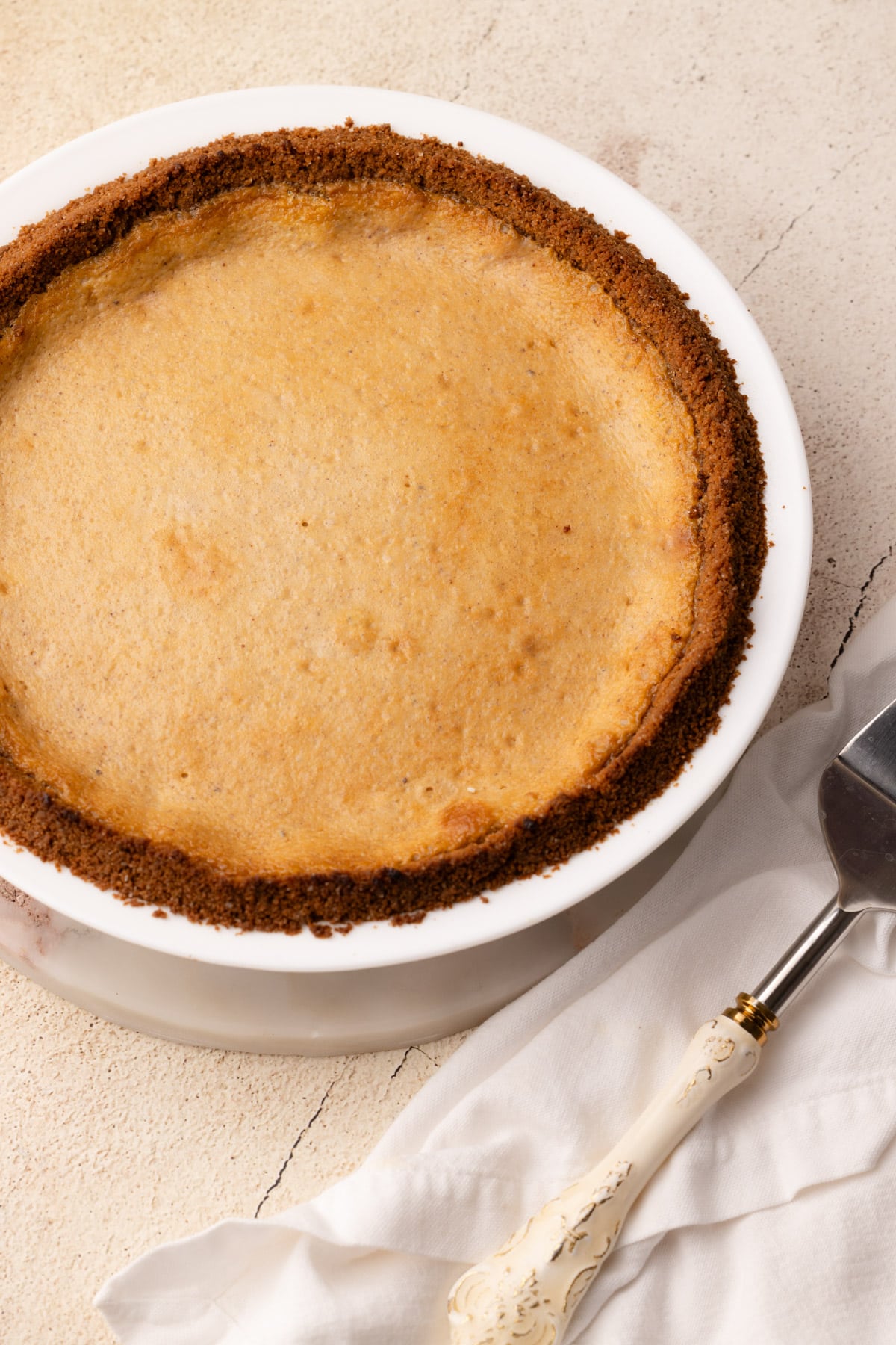 A baked Cinnamon Pie with a pie server next to it.