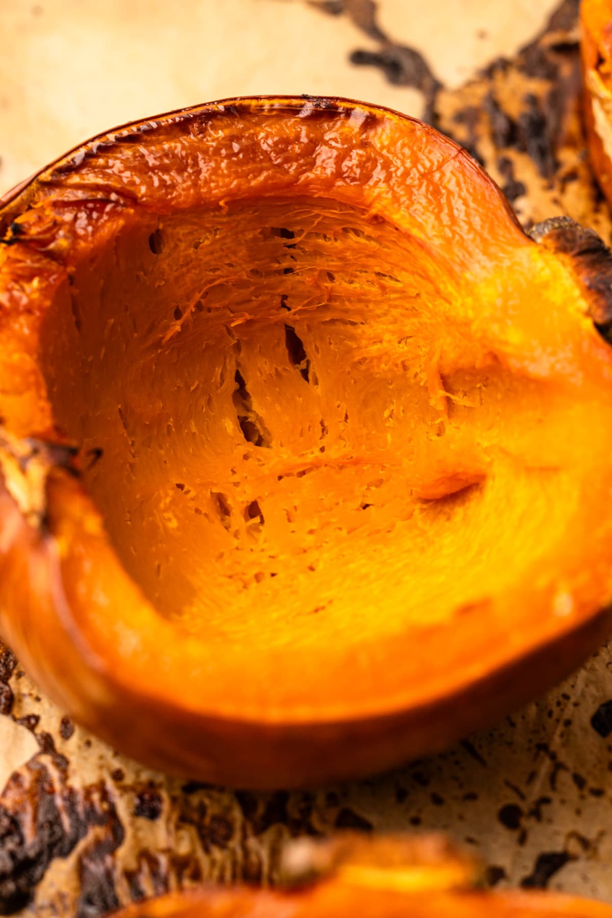 A baked pumpkin on a sheetpan.