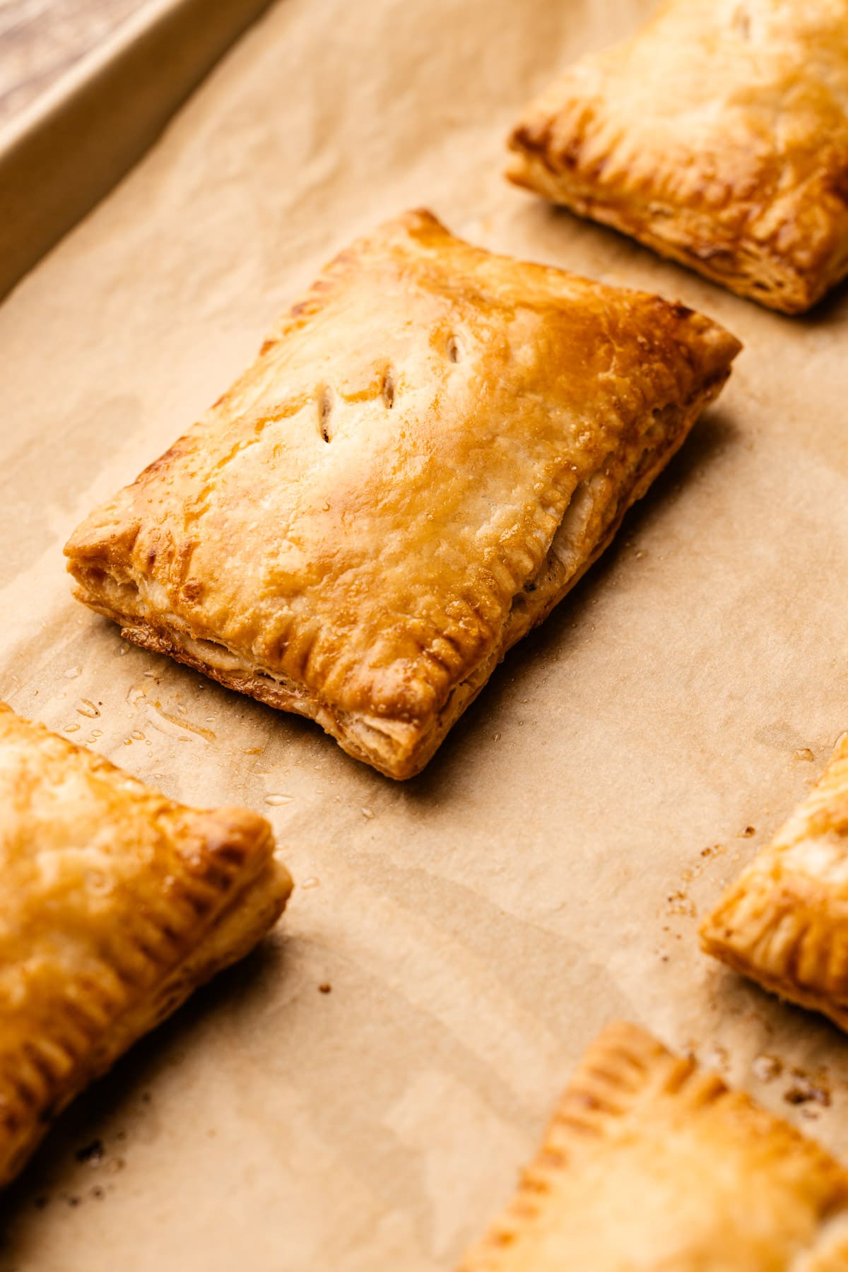 A fully baked turkey hand pie on a sheet tray.