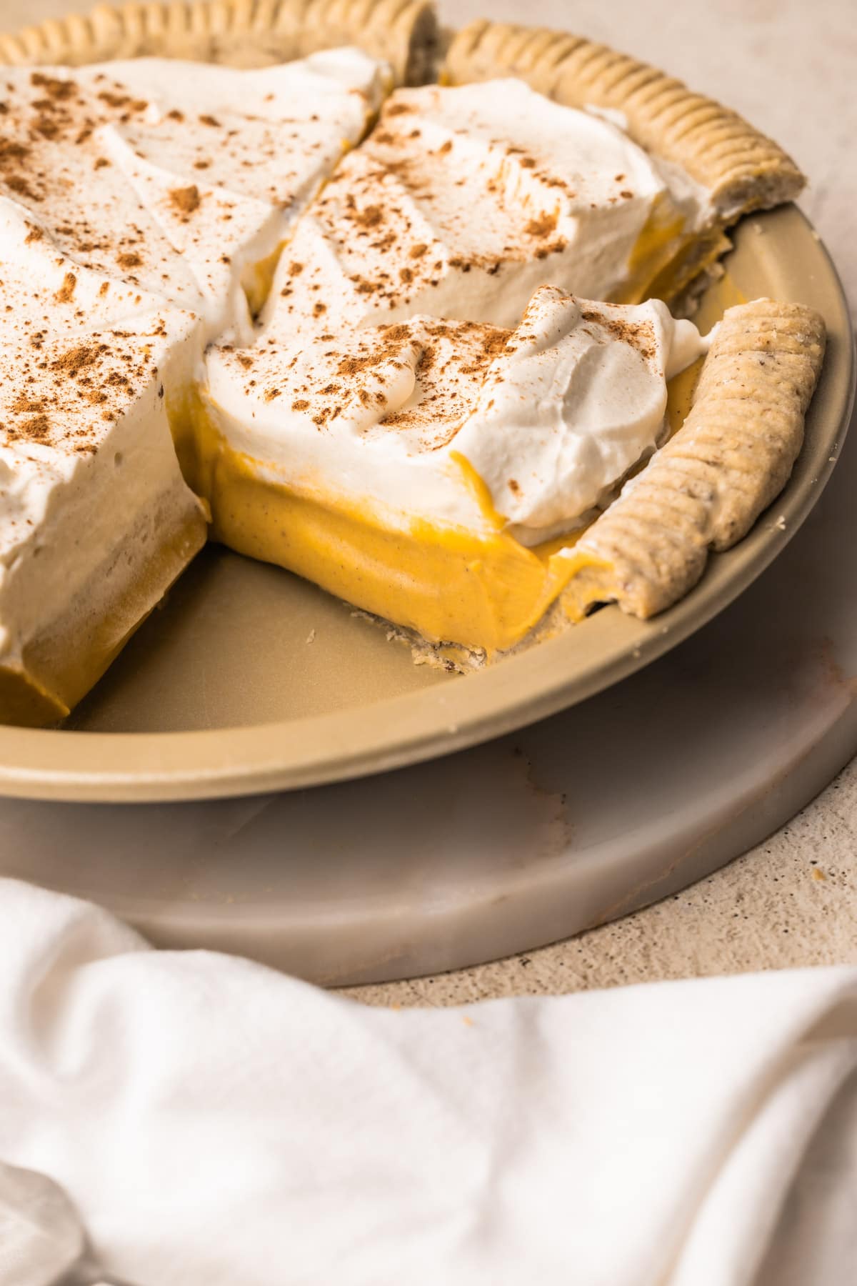 A Pumpkin Cream Pie cut into slices.