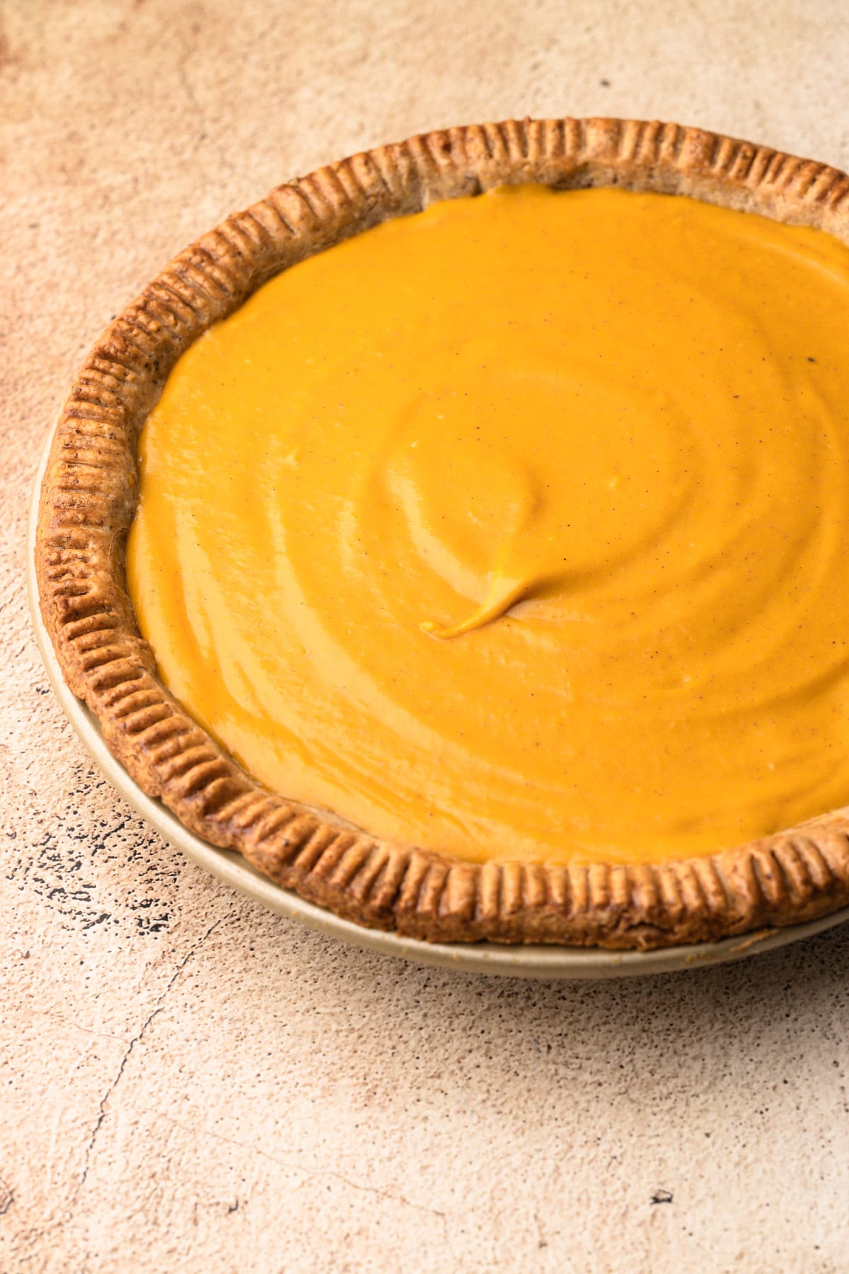 A baked pie shell filled with Pumpkin Cream Pie filling.