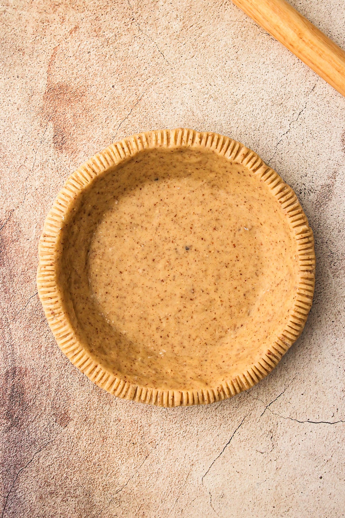 A crimped pie shell for Pumpkin Cream Pie.